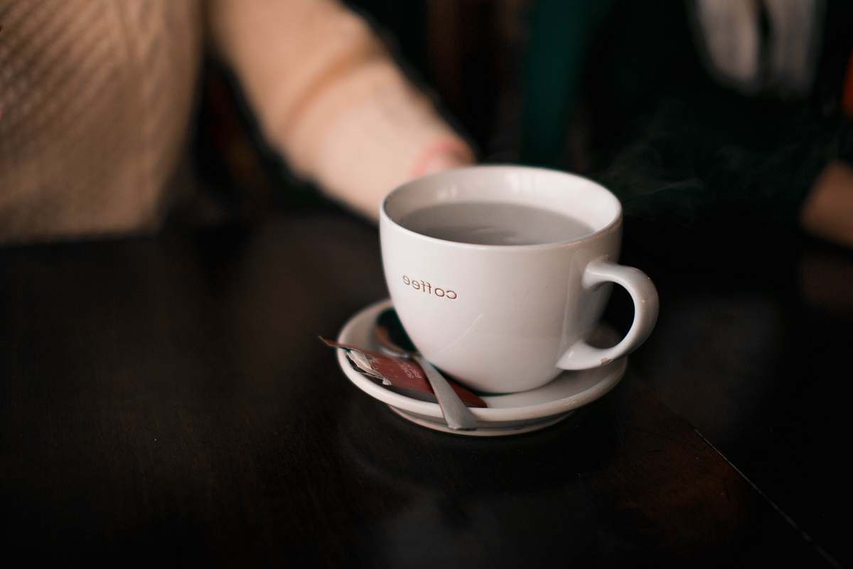 coffee cup shallow focus photography of coffee cup saucer
